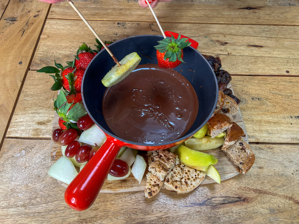 Easter vegan chocolate fondue pot surrounded by delicious dippables